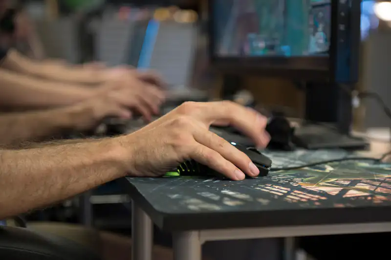 Close-up of players' hands on keyboards and mice at an esports tournament