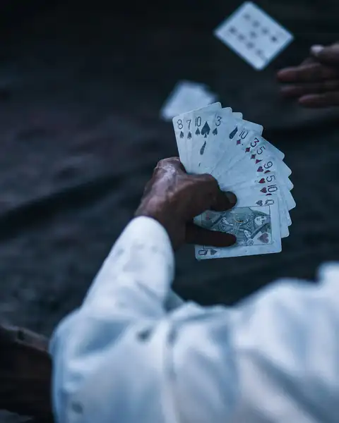 Man holding a fanned hand of playing cards